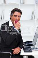 Smiling businessman eating an apple