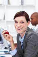 Portrait of a smiling businesswoman eating an apple