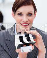 Portrait of a young businesswoman consulting her business card h