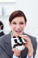 Smiling businesswoman holding a card holder