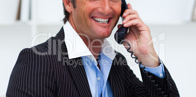 Close-up of a smiling businessman talking on phone