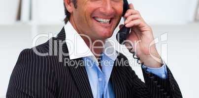 Close-up of a smiling businessman talking on phone