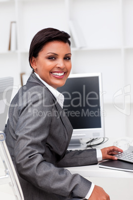 Attractive female executive working at a compute
