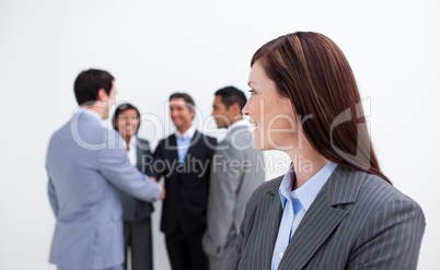Attractive female executive looking at her team