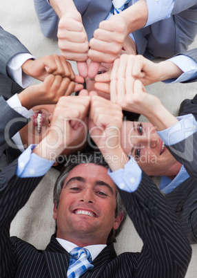 Business team lying on the floor in a circle