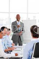 Confident Afro-American businessman discussing with his team