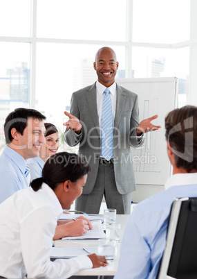 Smiling businessman doing a presentation to his colleagues