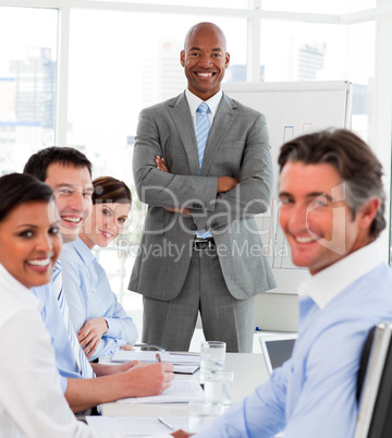 Afro-american businessman giving a presentation to his team