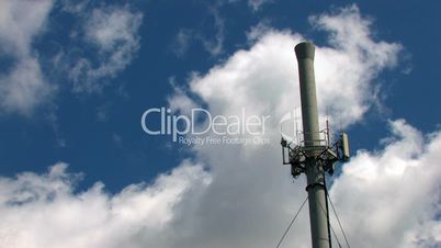 HD telecomunication tower on a blue sky with clouds, time lapse