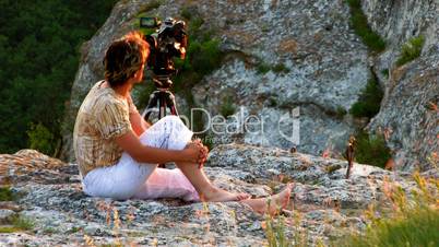 HD videographer on sunset mountain