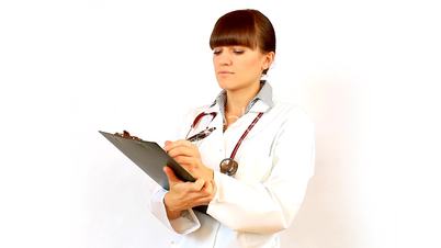 Female doctor recording something on notepad