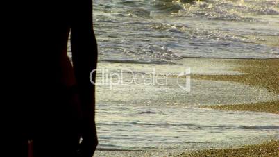 HD young couple walking on the seashore