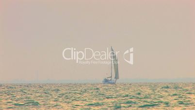 HD sailing yacht in the sea at sunset