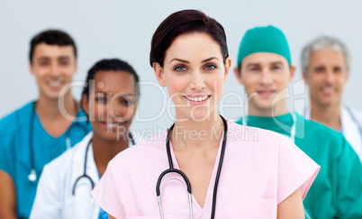 Female Doctor standing in Front of her team