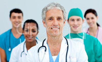 Senior doctor standing in front of his team