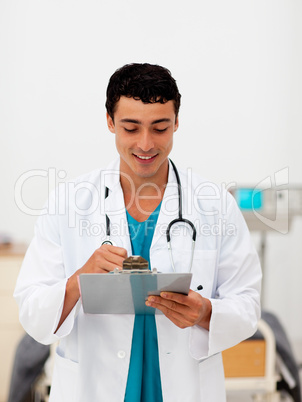 Young male Doctor holding a clip board