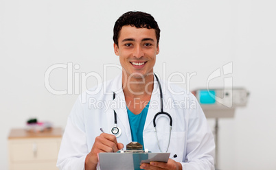 Young male Doctor holding a clip board