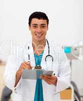 young male doctor holding a clip board