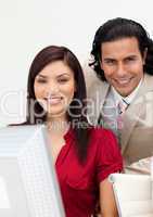 Man and woman working together smiling at the camera