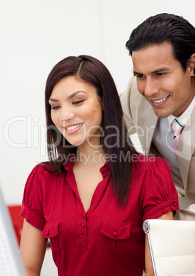 Happy business people working at a computer