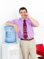 Businessman on phone by the watercooler