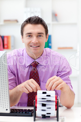 Smiling businessman consulting his business card holder