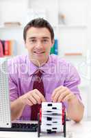 Smiling businessman consulting his business card holder