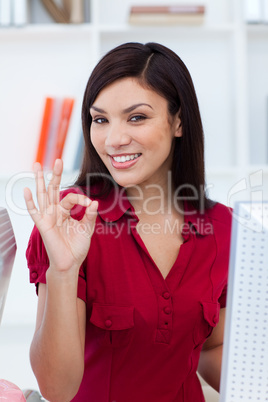 Ethnic businesswoman showing OK sign