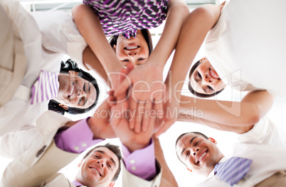 Smiling business people holding hands together in a circle