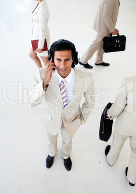 Attractive businessman on phone smiling at the camera
