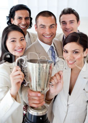 A successful business team holding a trophy