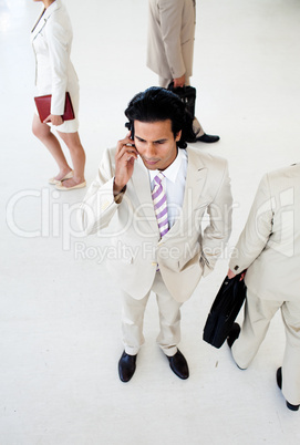 Attractive businessman on phone in a business building