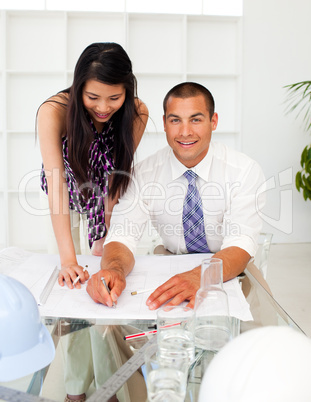 A diverse group of architects reviewing blueprints