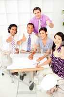 A group of architects with thumbs up in a meeting