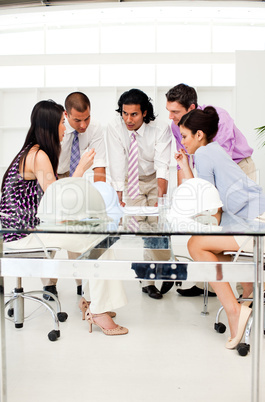A group of architects and their manager discussing blueprints