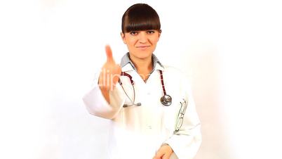 A Young woman doctor smiles and shows thumb up