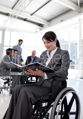 Businesswoman in a wheelchair reading a report