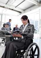 Businesswoman in a wheelchair reading a report