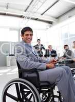 Young businessman in a wheelchair at a meeting