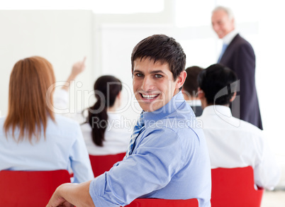 Attractive businessman smiling at the camera