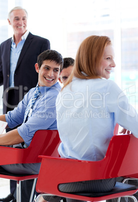 Smiling business people discussing at a conference
