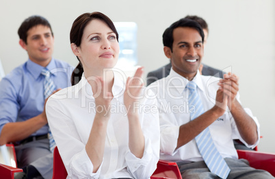 International business people clapping at a conference