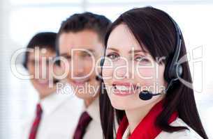 Business team with headset on smiling at the camera