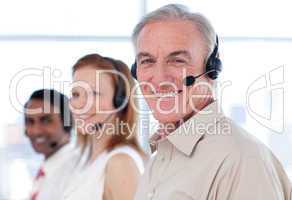 Senior businessman working in a call center