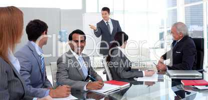 Businessman reporting sales figures to his team