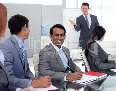 Young businesman studying a new business plan with his team
