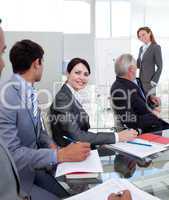 Young businesswoman studying a new business plan with her collea