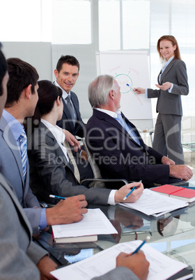 Smiling manager giving a presentation to her team