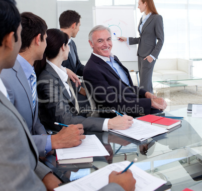 Confident businesswoman giving a presentation to her team