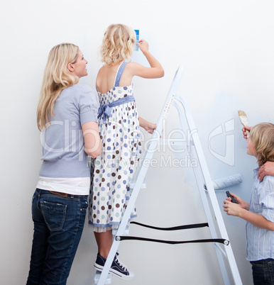 Young family paiting a room